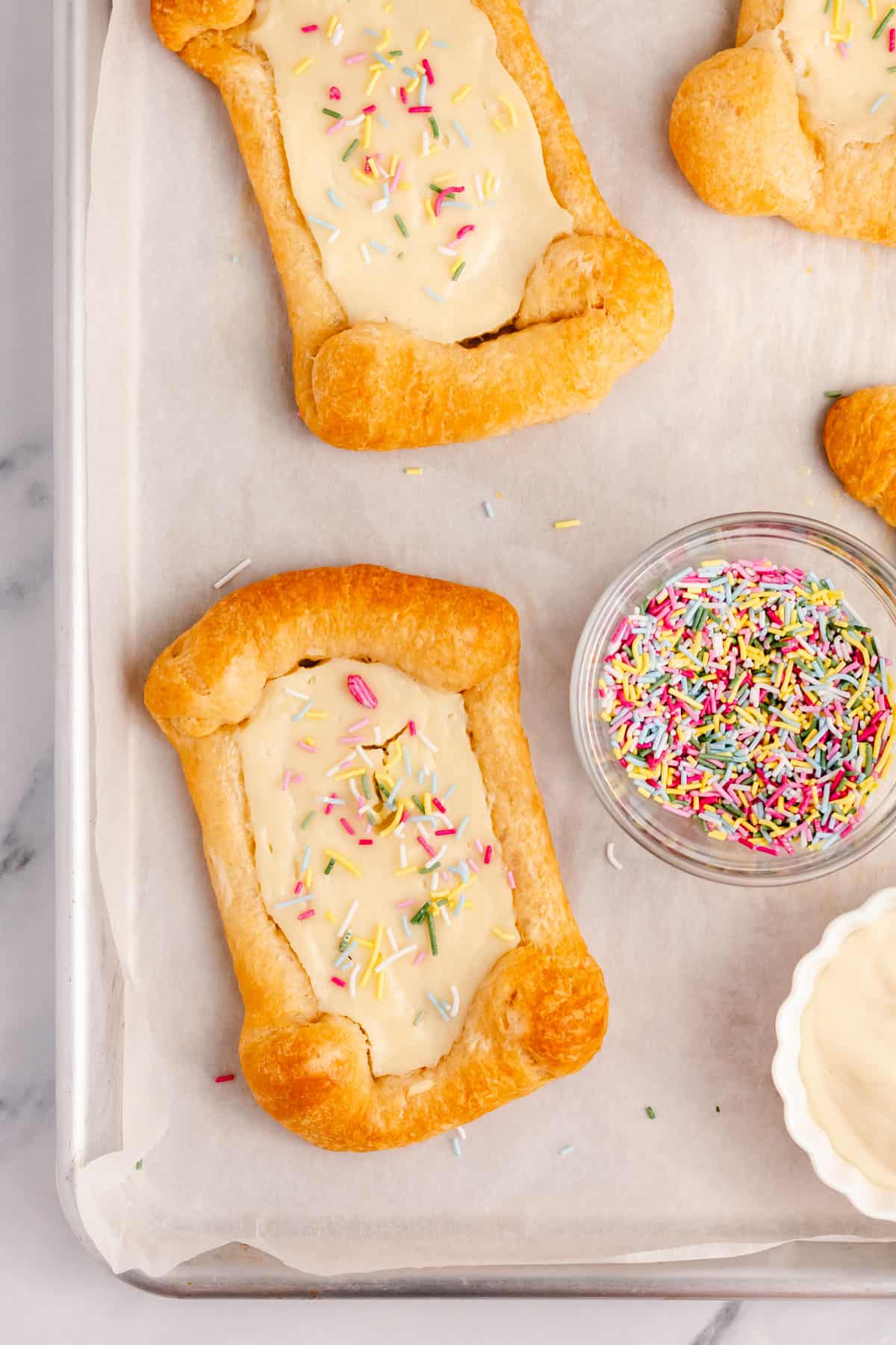 crescent roll cream cheese danishes topped with rainbow sprinkles