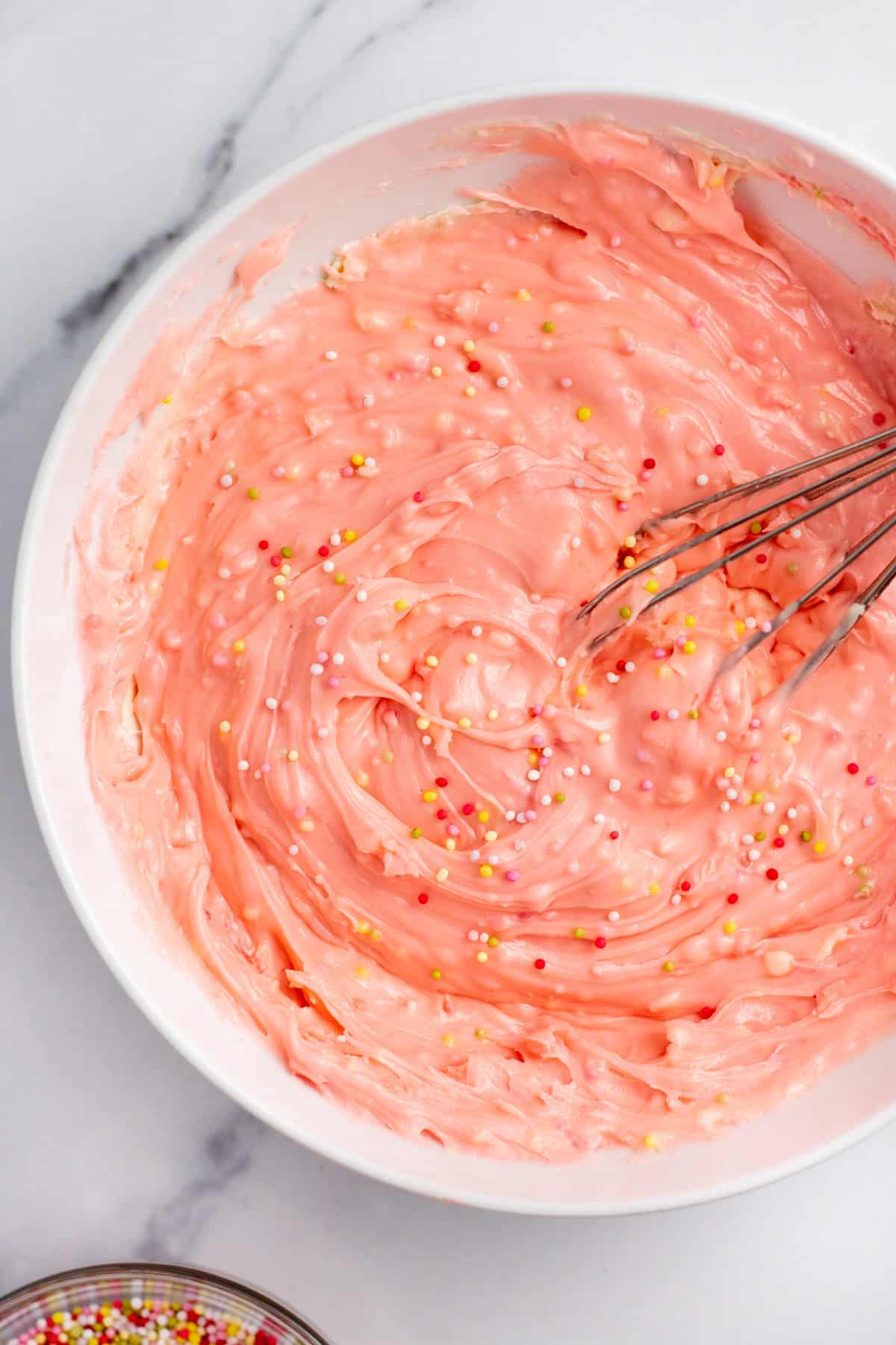 pink colored fudge in a mixing bowl