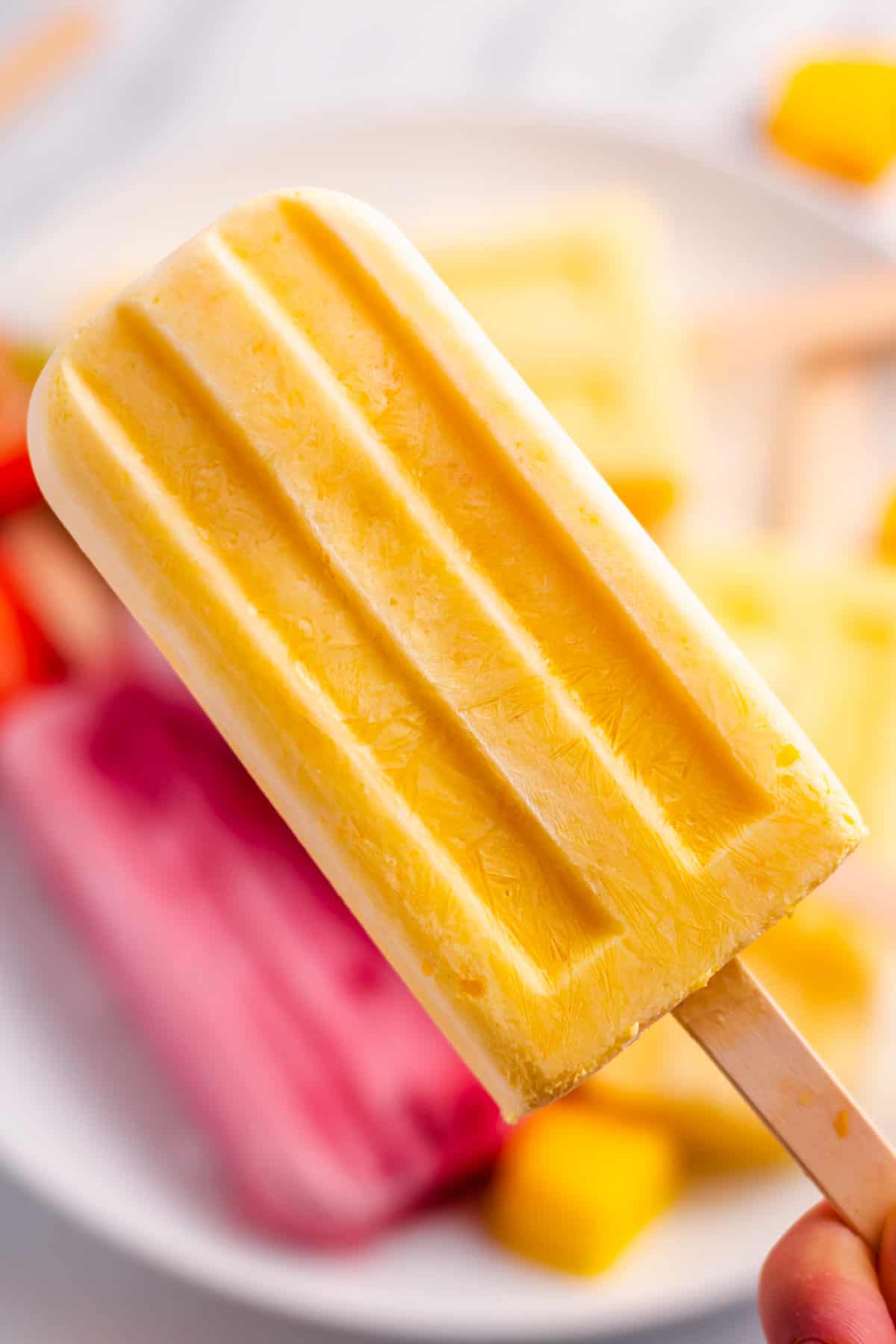 close up of a homemade mango popsicle
