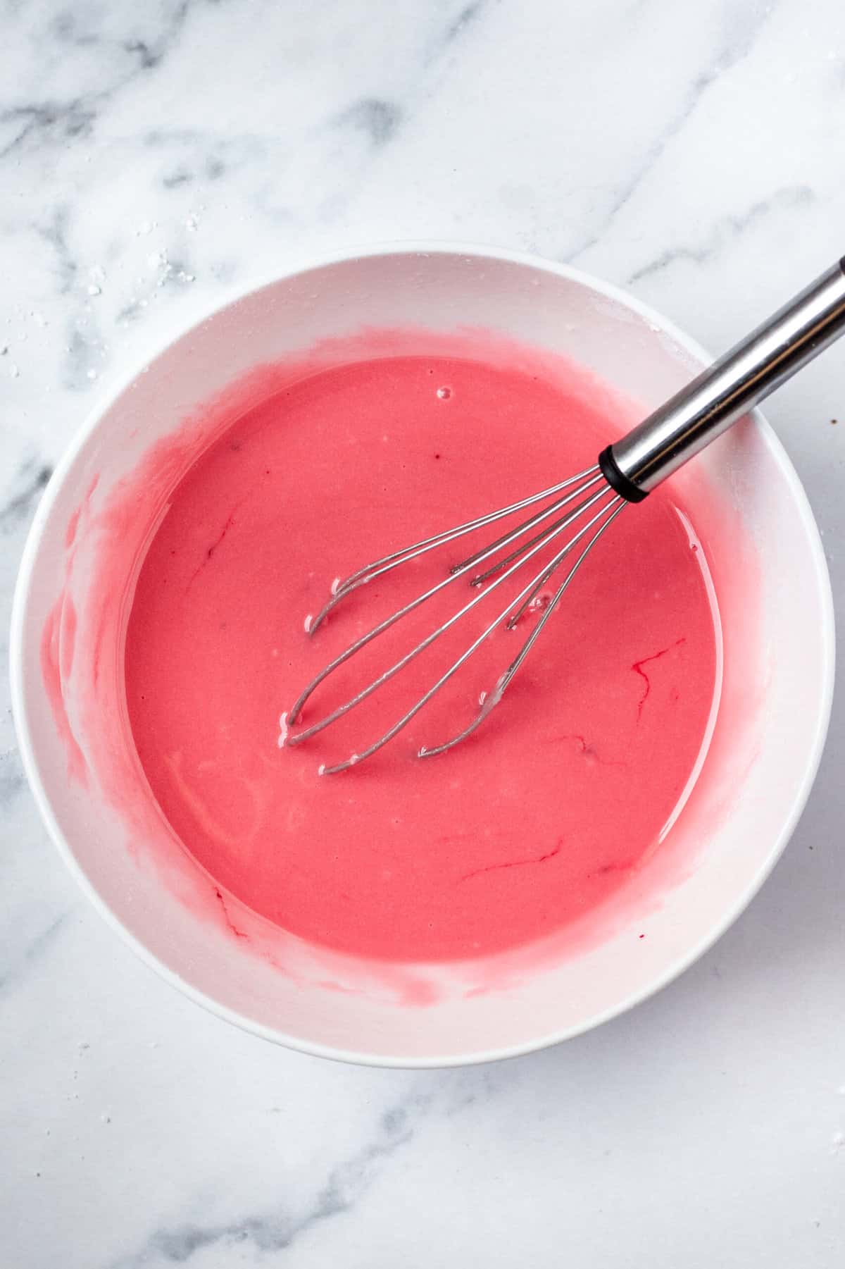 pink icing in a mixing bowl