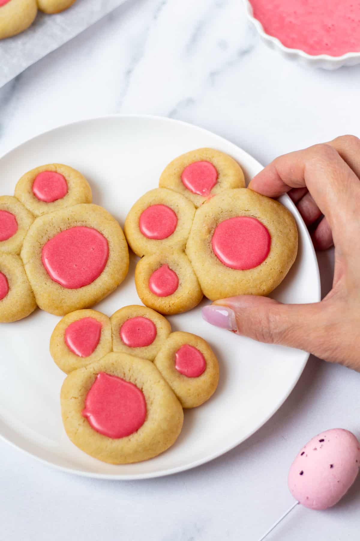 bunny paw cookies on a white plate