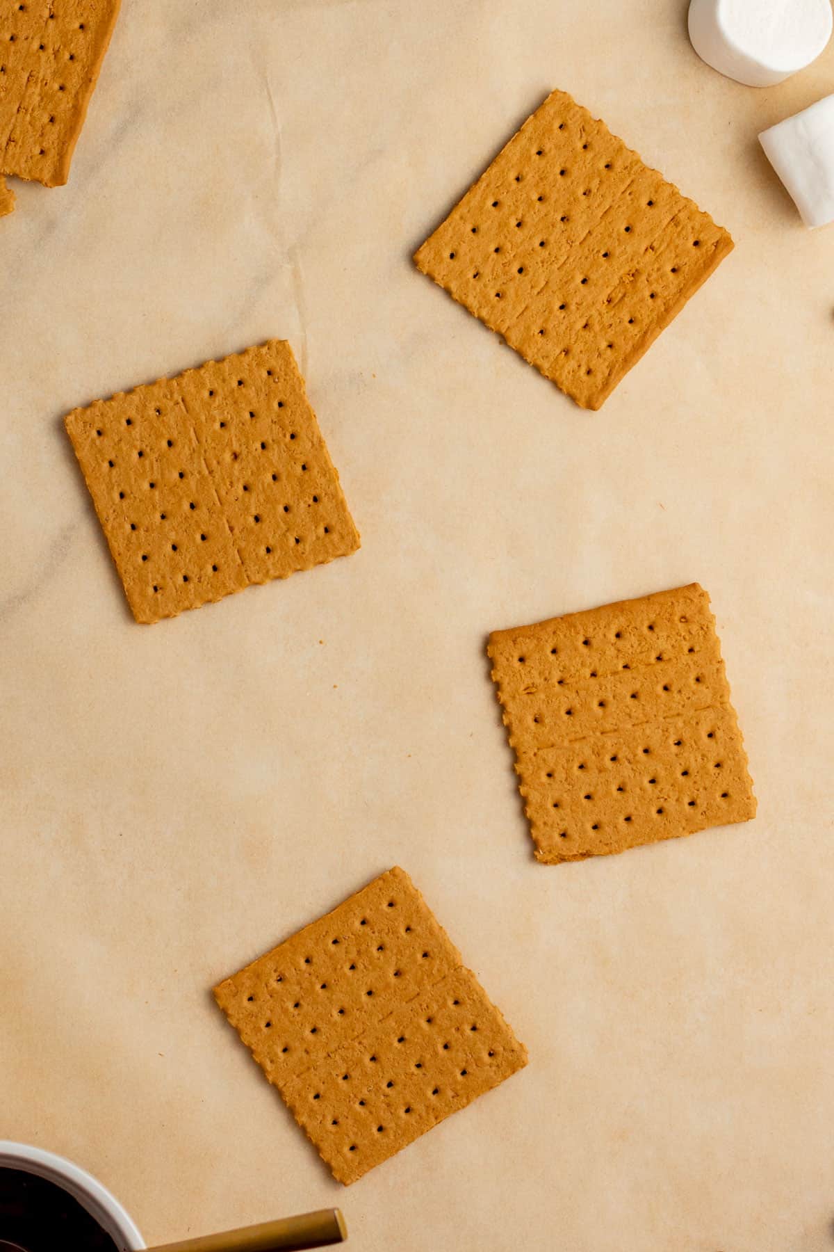 graham crackers halves on a piece of parchment paper