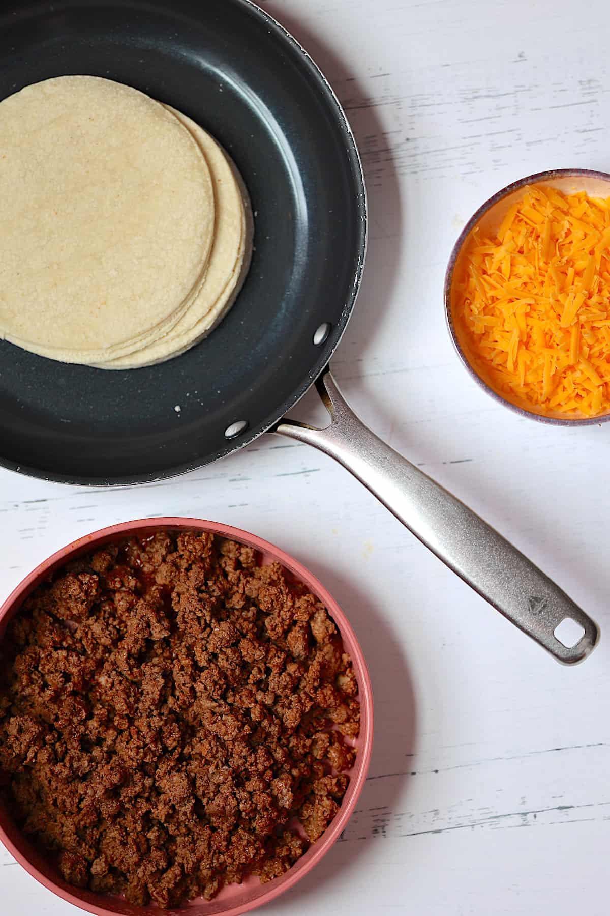 corn tortillas, ground beef, and cheddar cheese