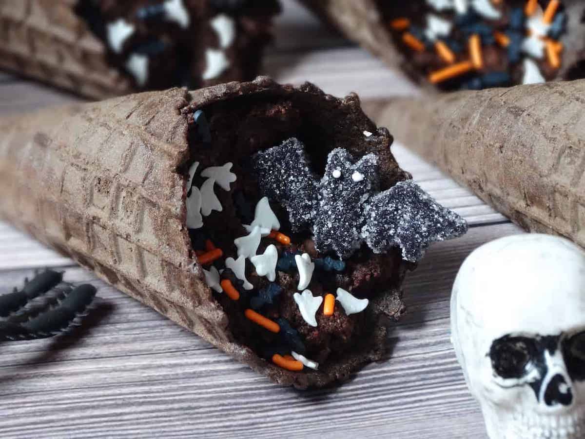 no bake brownie bites in ice cream cones and decorated with bat candy