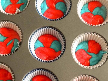 red and blue batter in muffin tins
