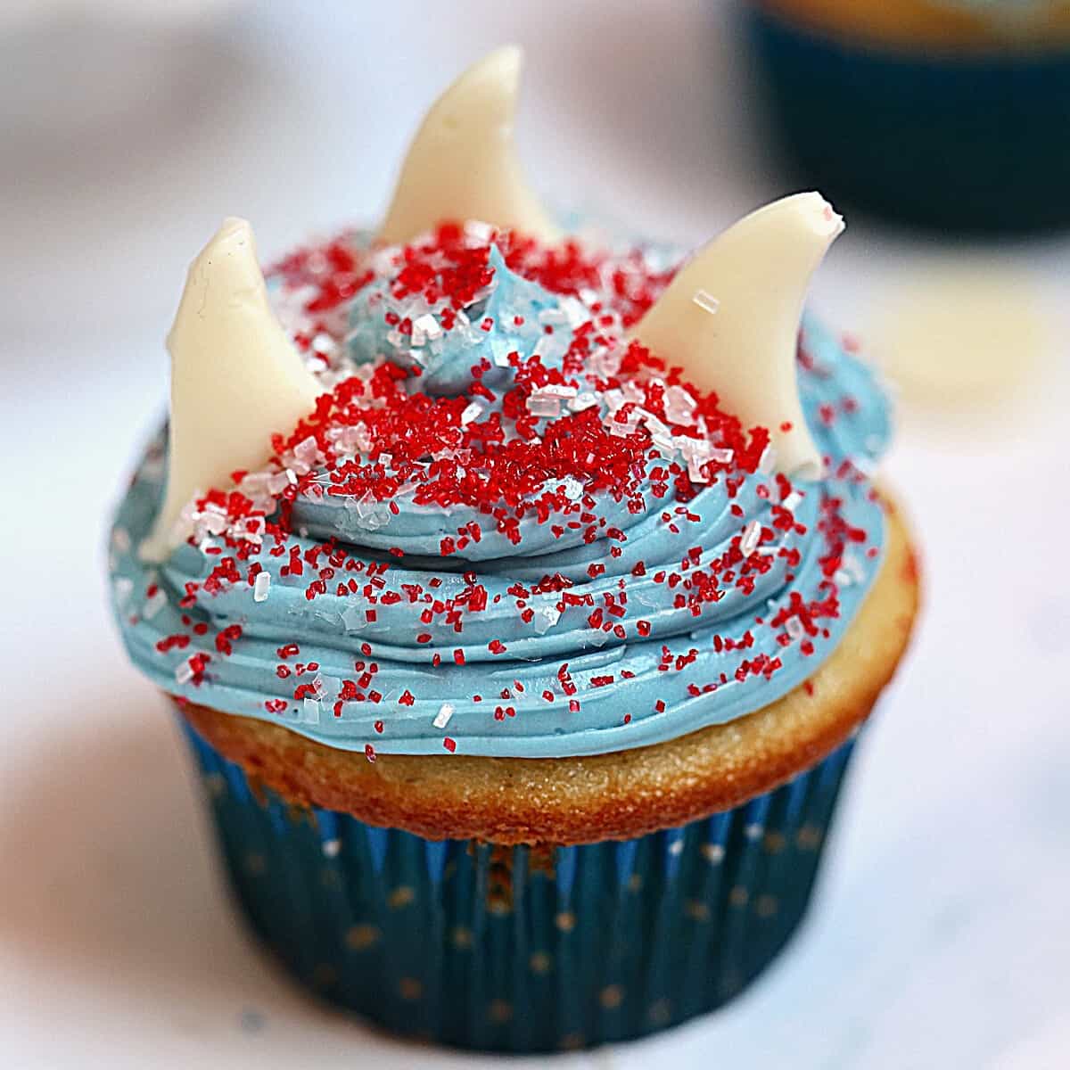 shark cupcake with three fins and sprinkles