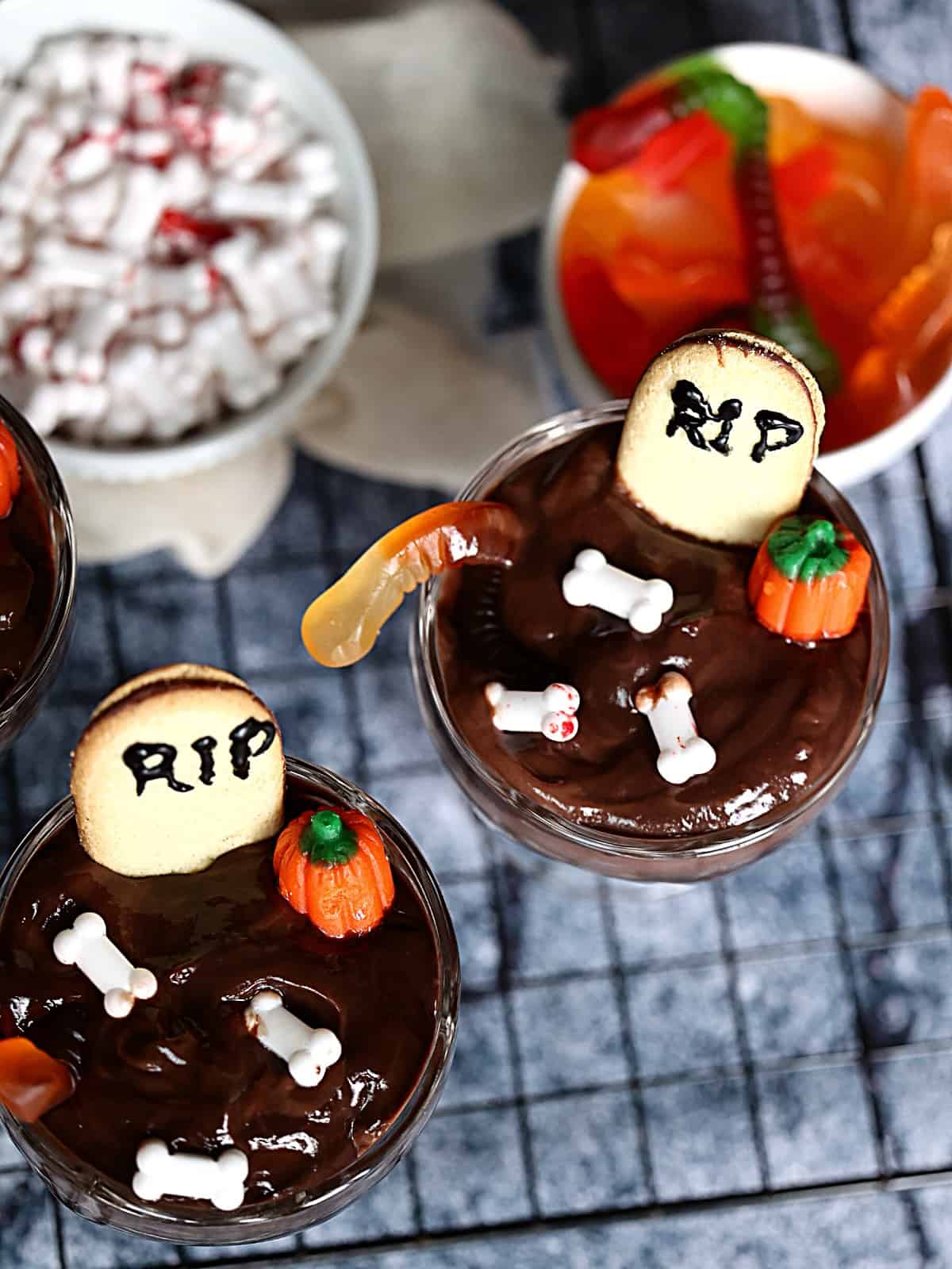 halloween graveyard pudding cups with bones, pumpkins and worms