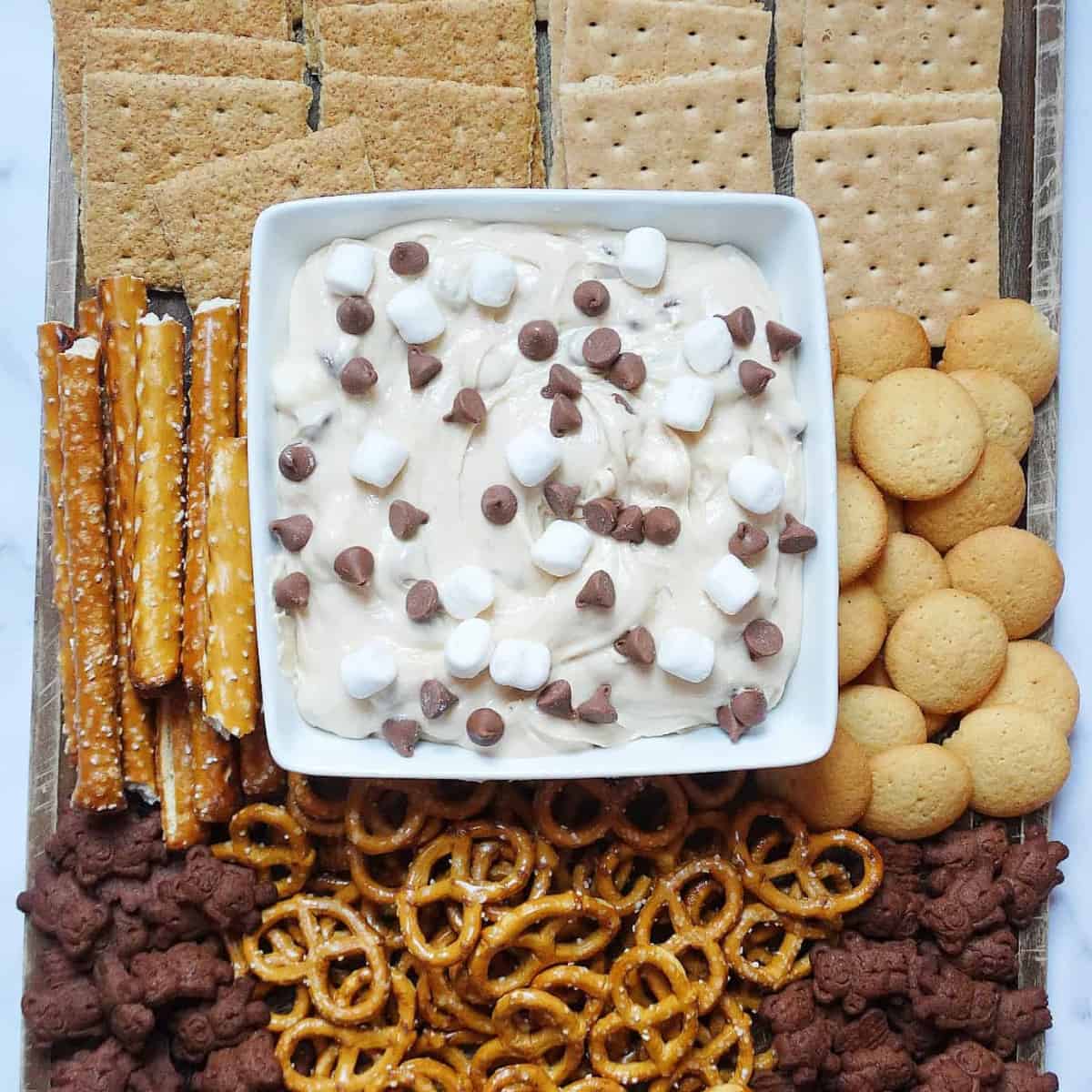 smores board with pretzels and other dippers and cookie dough dip