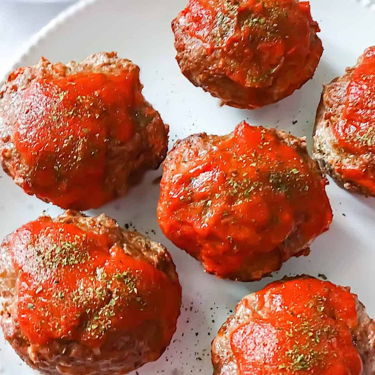 muffin tin meatloaves on a white plate