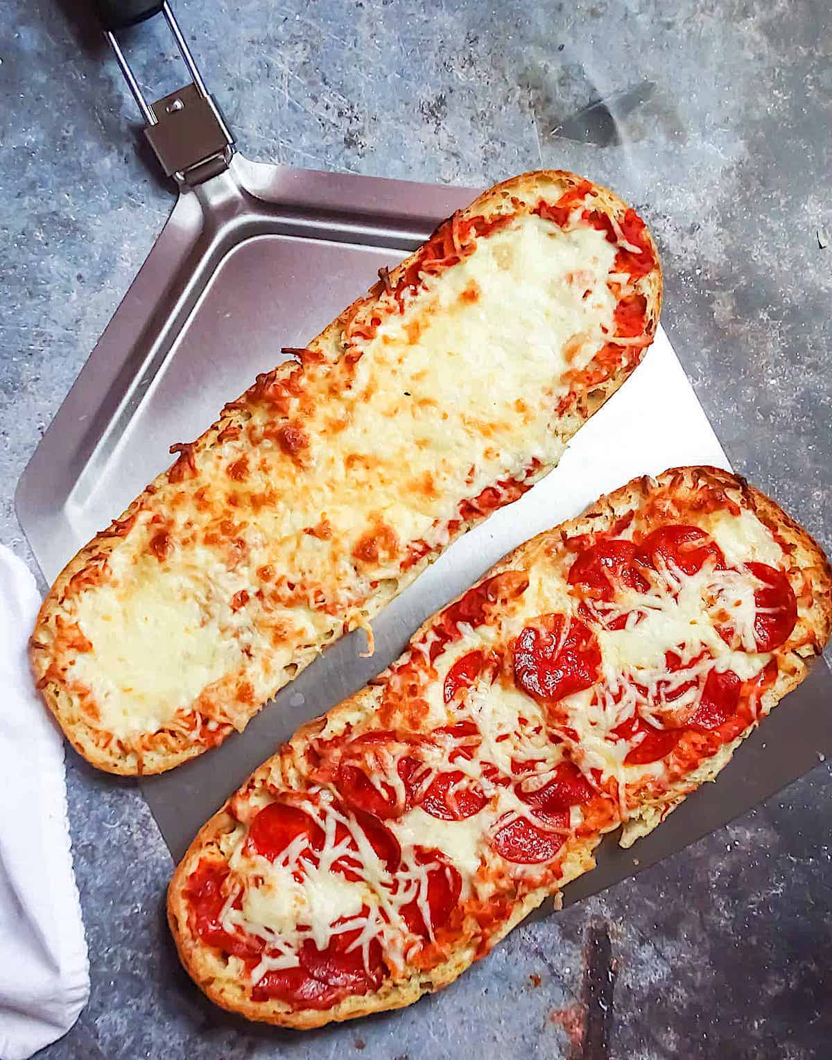cooked pizza boats on a pizza peal