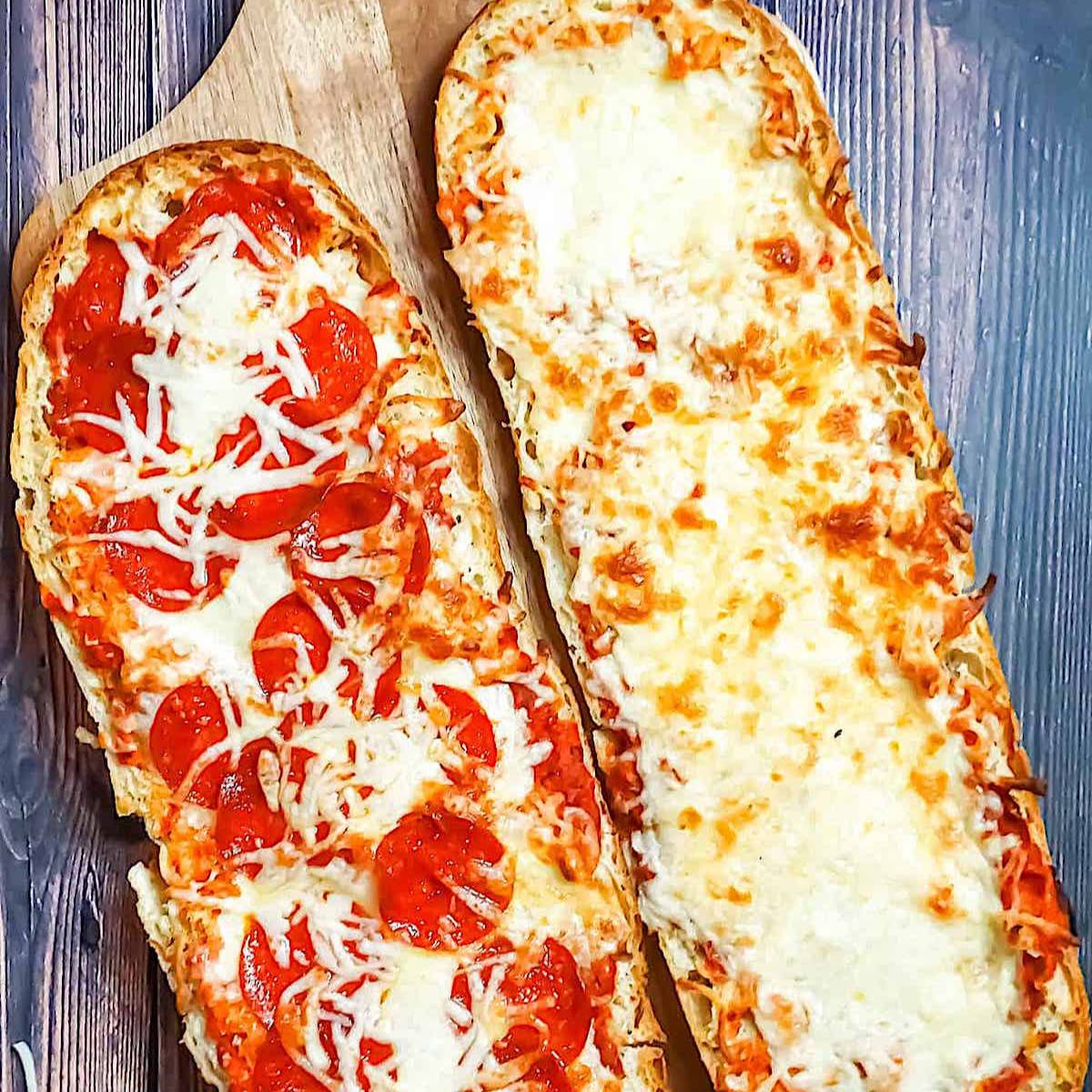 pizza boats with pepperoni and cheese on a pizza peel
