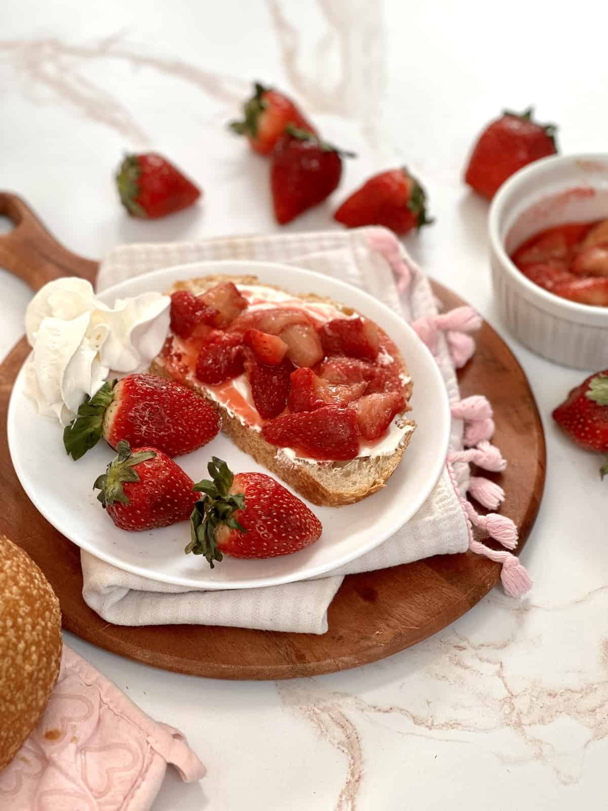 side angle of strawberry cream cheese toast with fresh strawberries