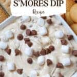 s'mores dip topped with chocolate chips and marshmallows in a white serving bowl