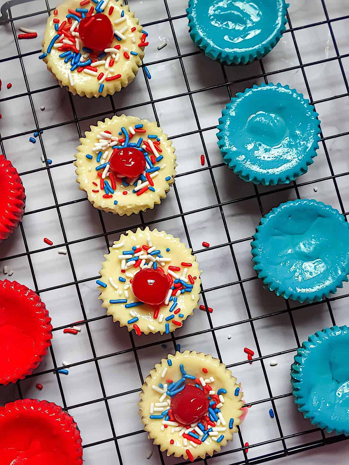patriotic mini cheesecakes decorated with cherries and sprinkles