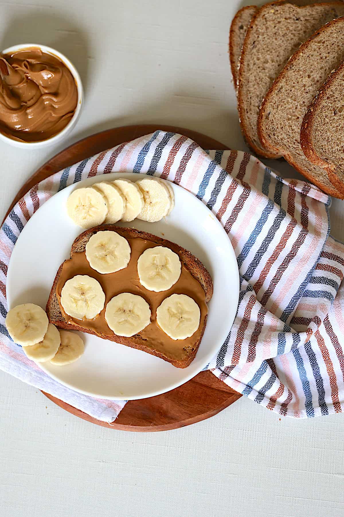 peanut butter banana toast on a white plate 