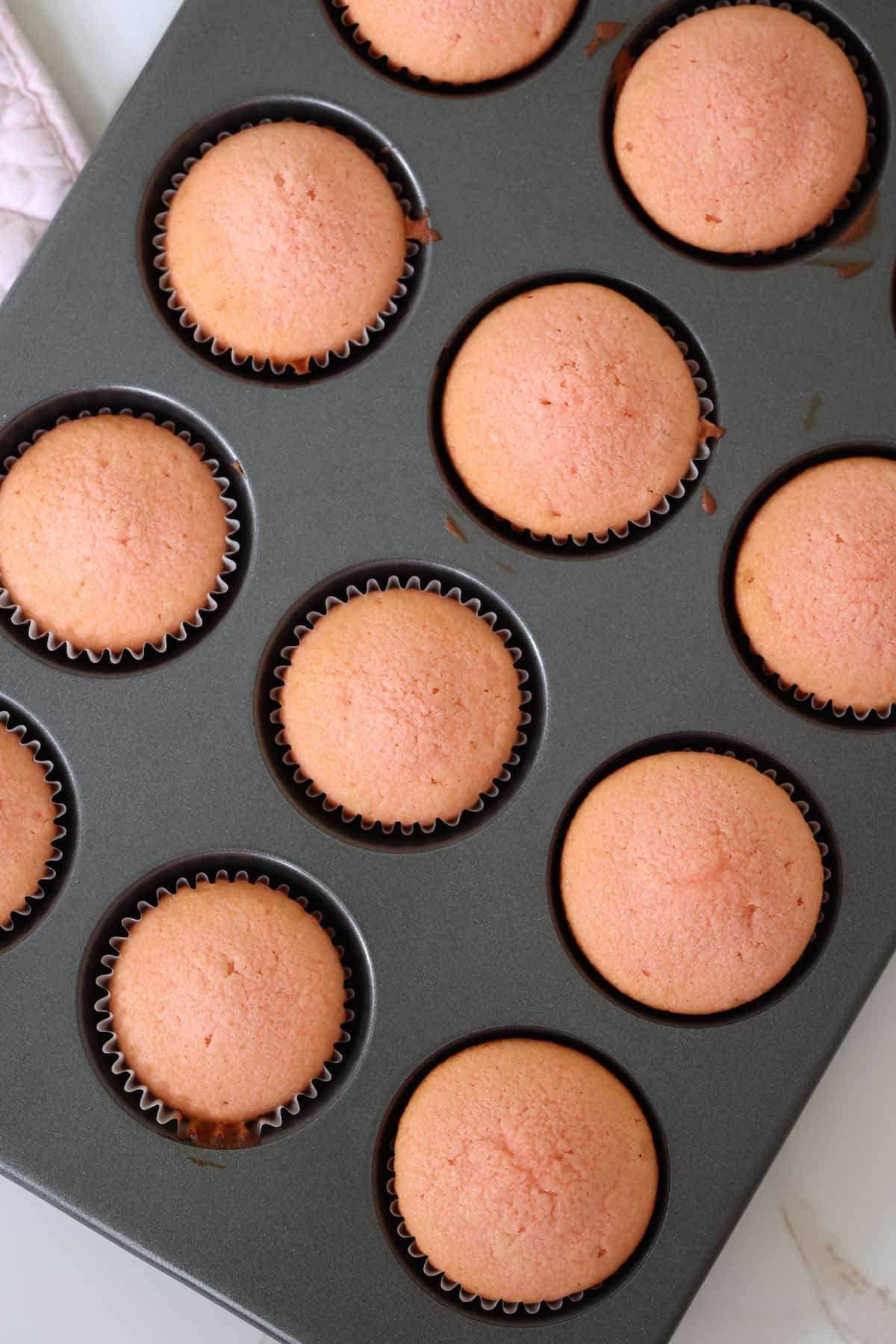unfrosted strawberry cupcakes cooked in a muffin pan