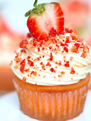 strawberry crunch cupcake with crispy topping on a white plate