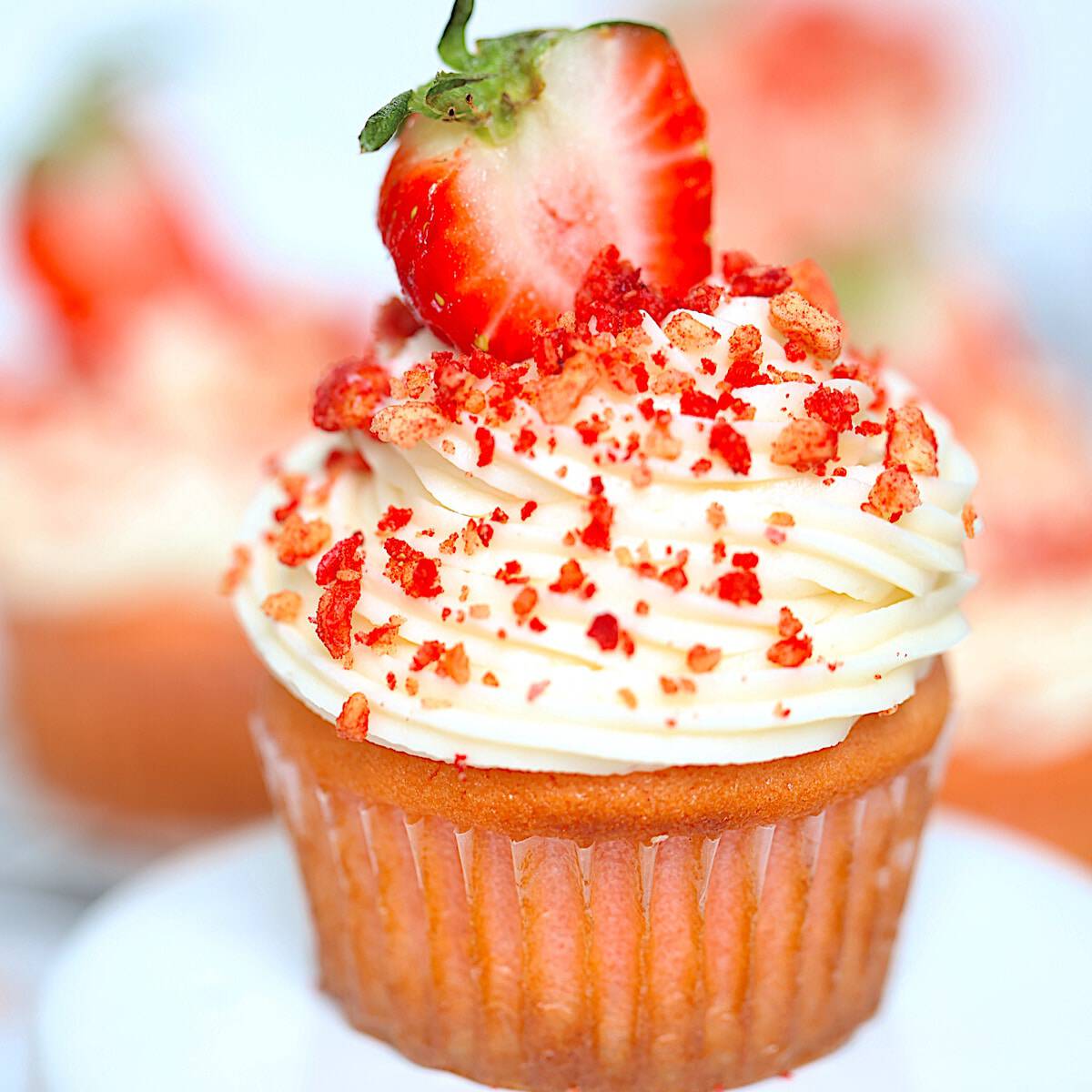 strawberry crunch cupcake with crispy topping on a white plate
