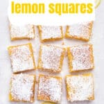 creamy lemon bars with powdered sugar on parchment paper