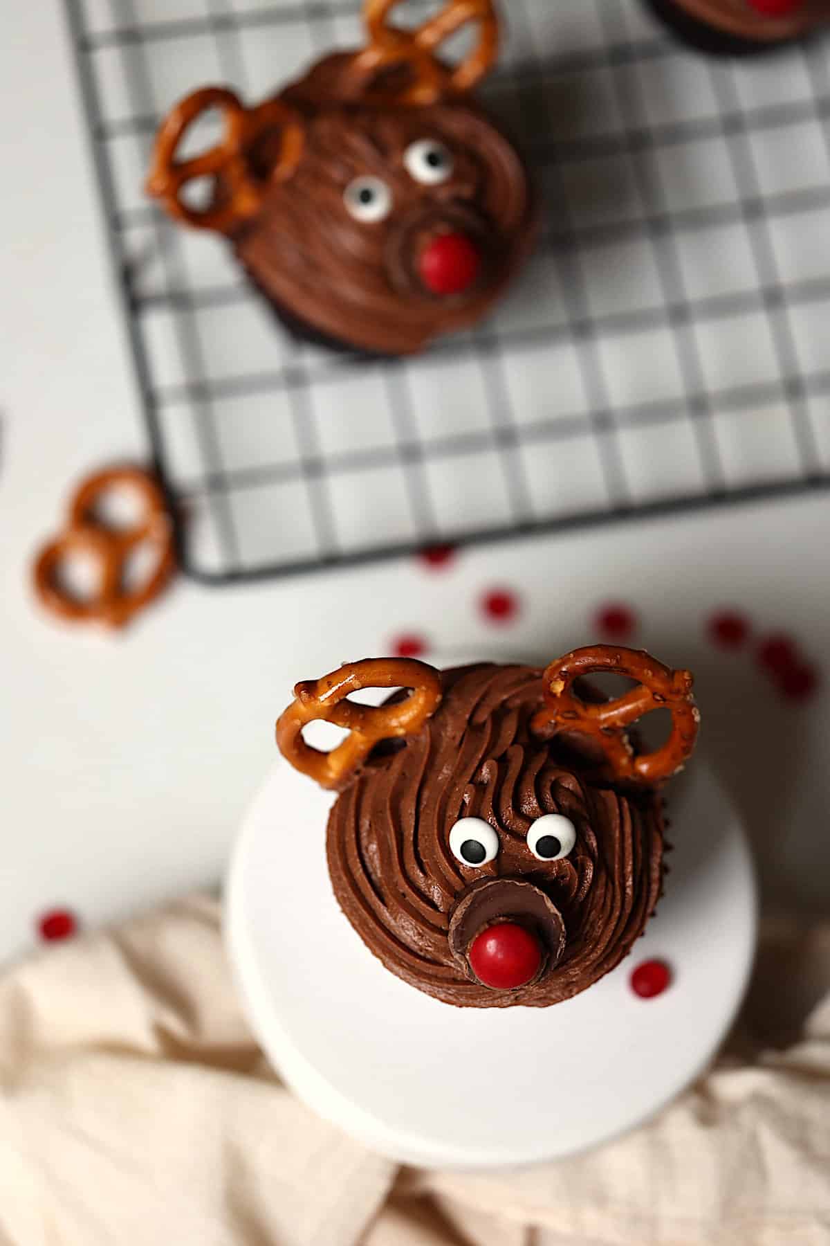 reindeer cupcakes on a white cupcake plate