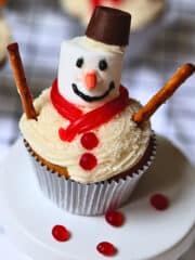 Christmas snowman cupcake with vanilla frosting and candy decorations