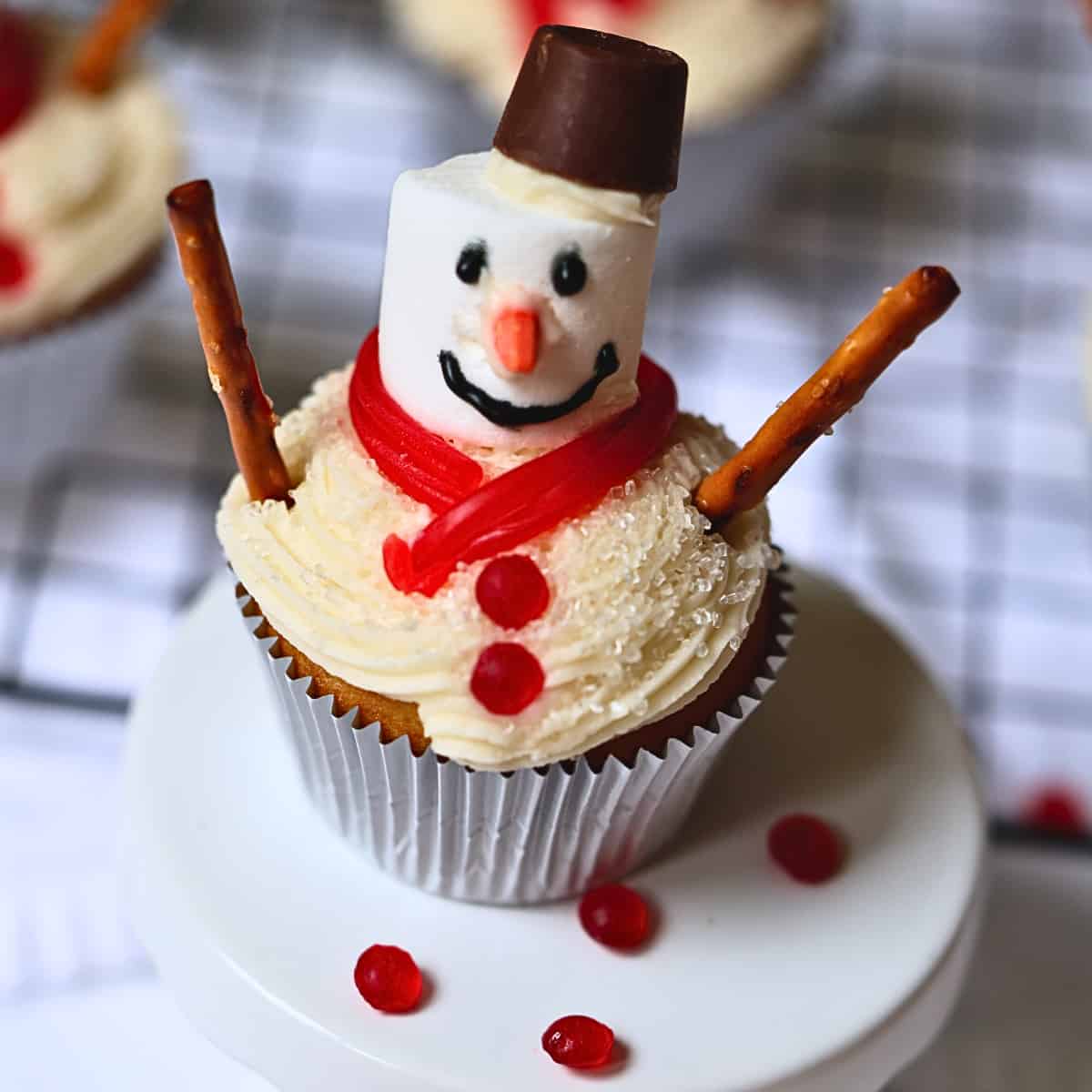 Christmas snowman cupcake with vanilla frosting and candy decorations