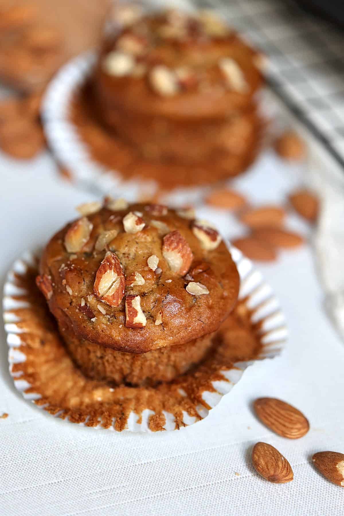 almond butter banana muffin in a liner on a serving plate