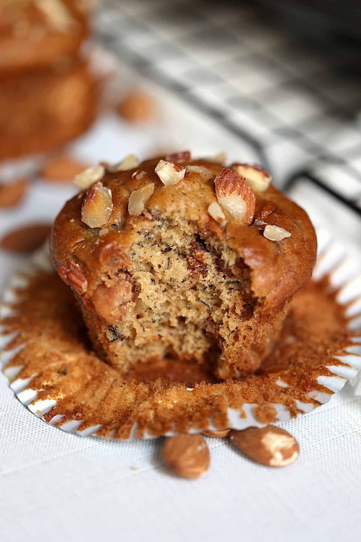 almond butter banana muffin with a bite on a serving board