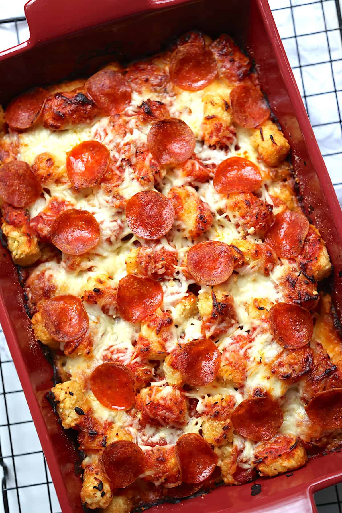 pizza tater tot casserole recipe in a red baking dish