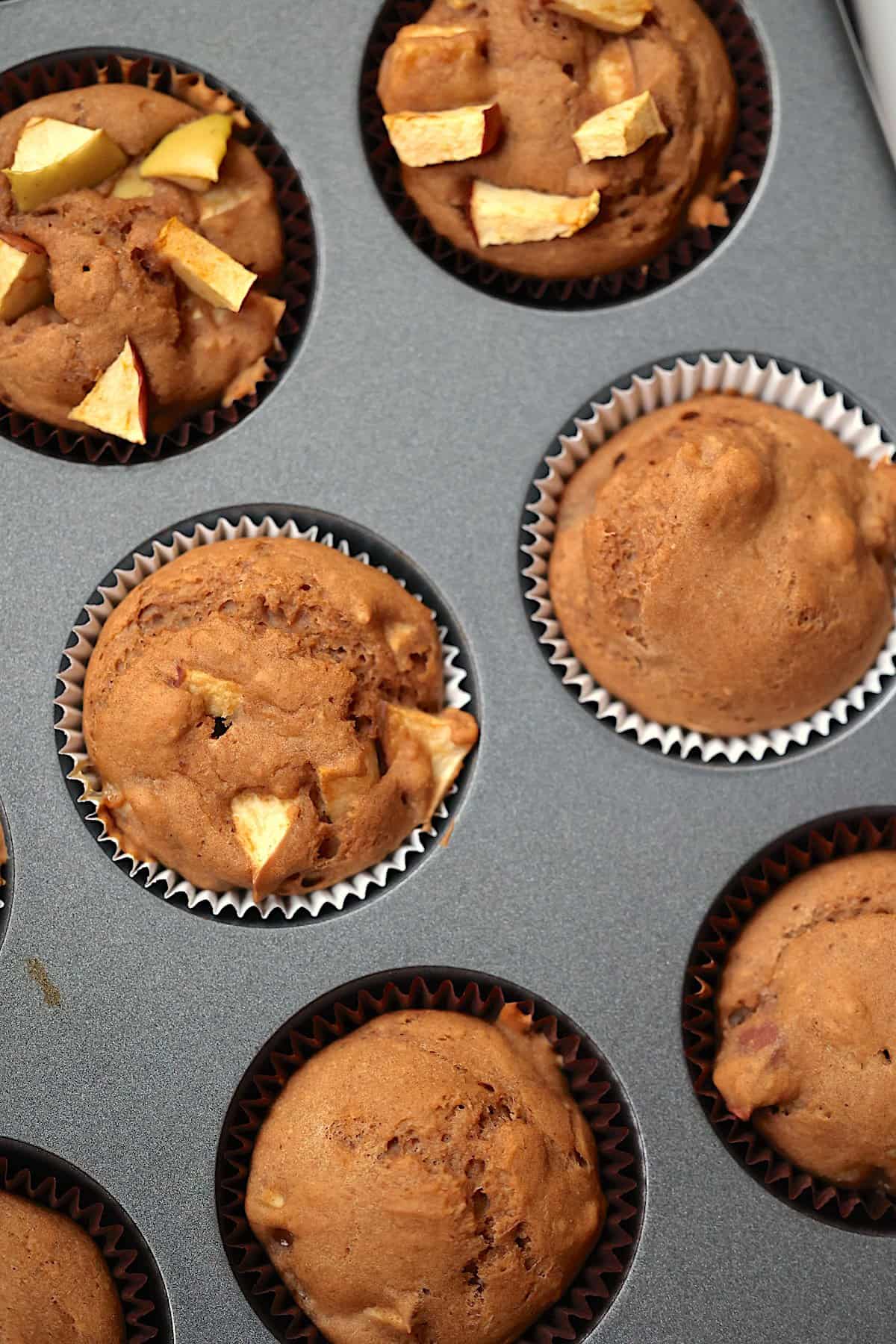 apple muffins with topping in a muffin tin