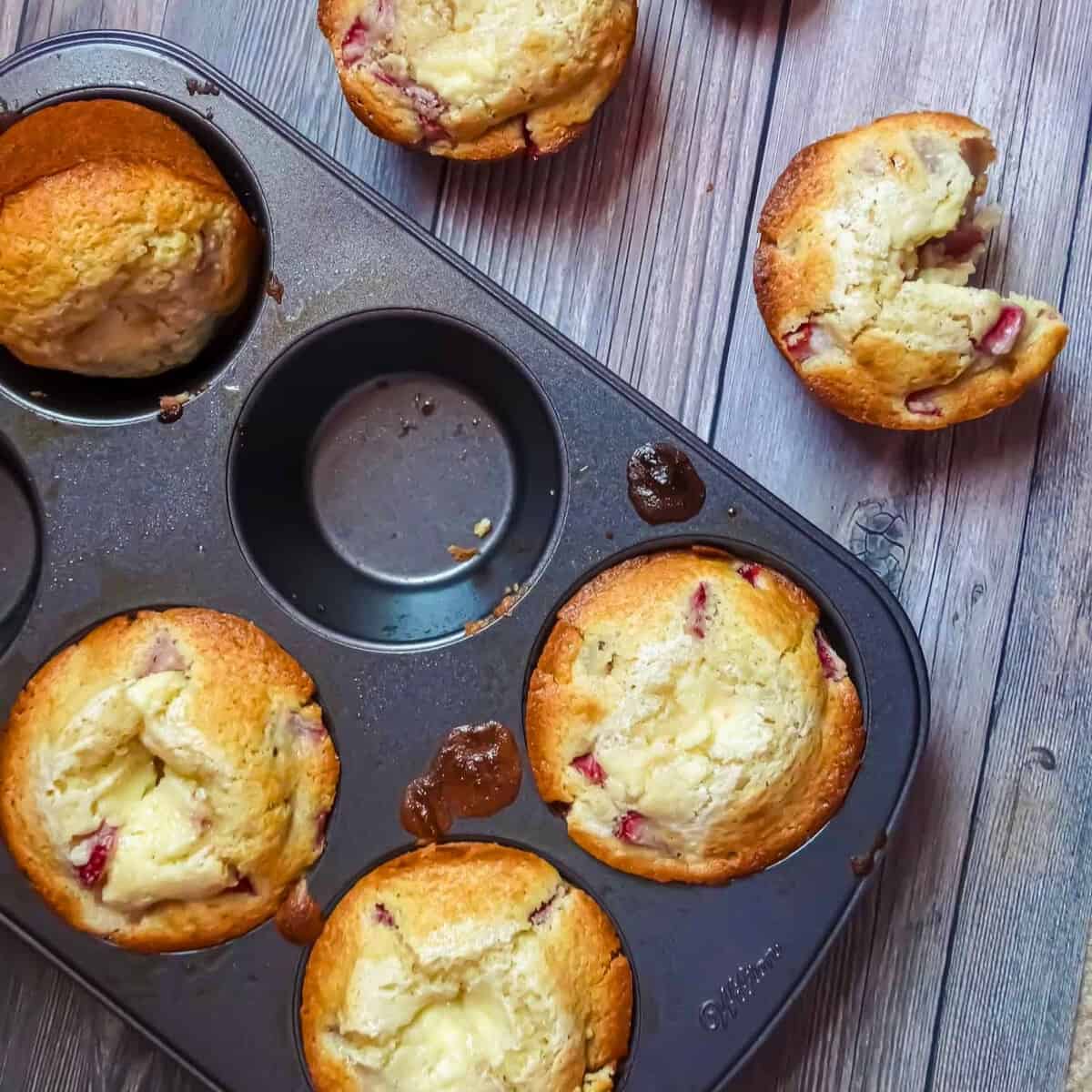 strawberry cream cheese filled muffins in a muffin tin