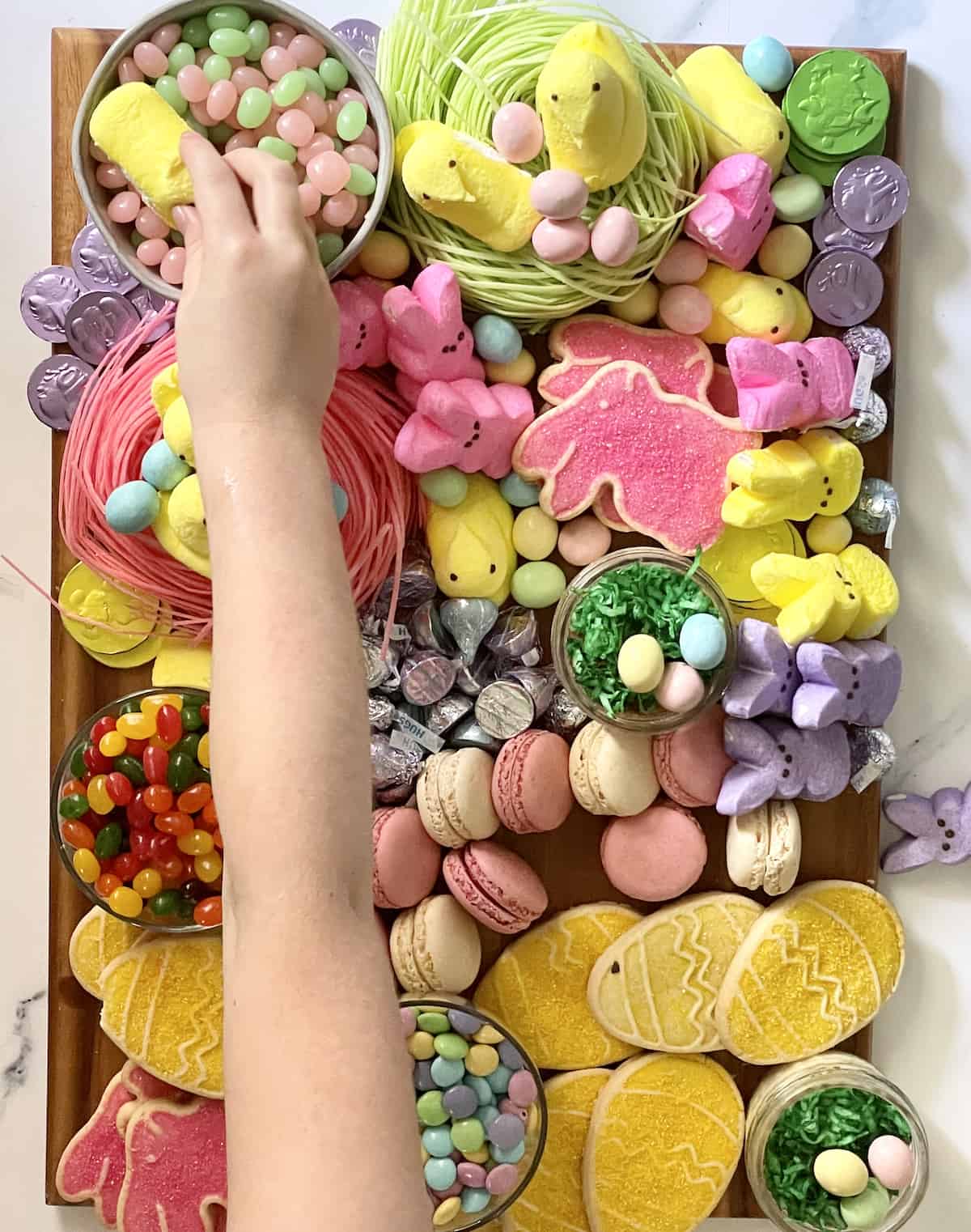 child helping to arrange a candy board for Easter