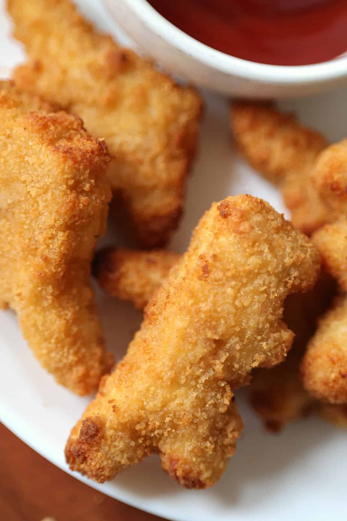 close up of air fried chicken nuggets on a plate