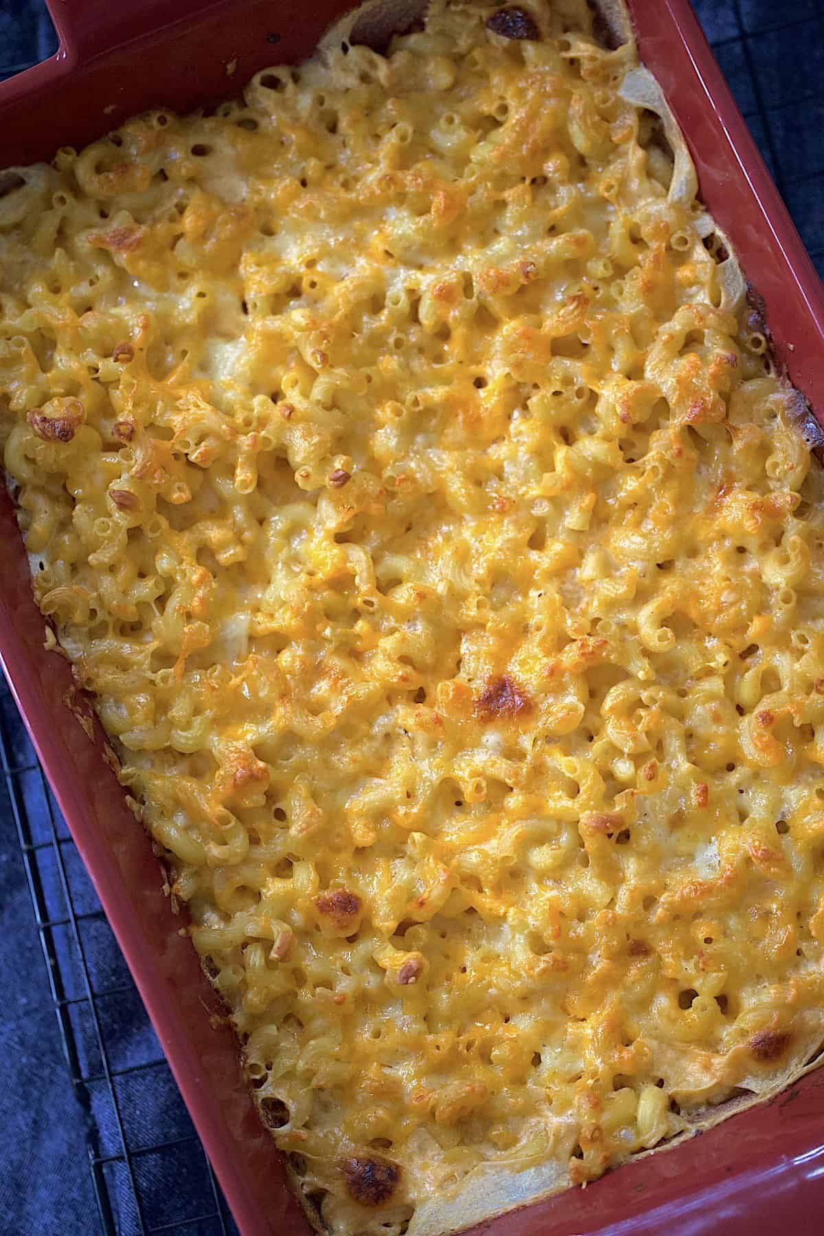 southern baked mac and cheese in a red casserole dish