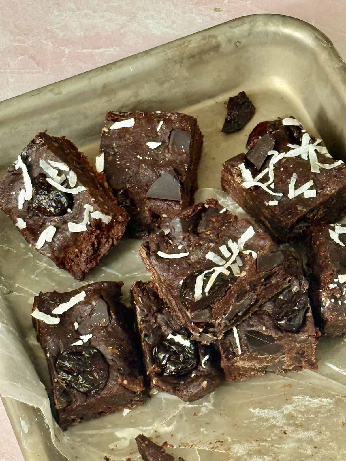 chocolate cherry date brownies sliced on a baking sheet