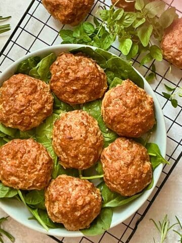 oven baked turkey burgers on a bed of spinach