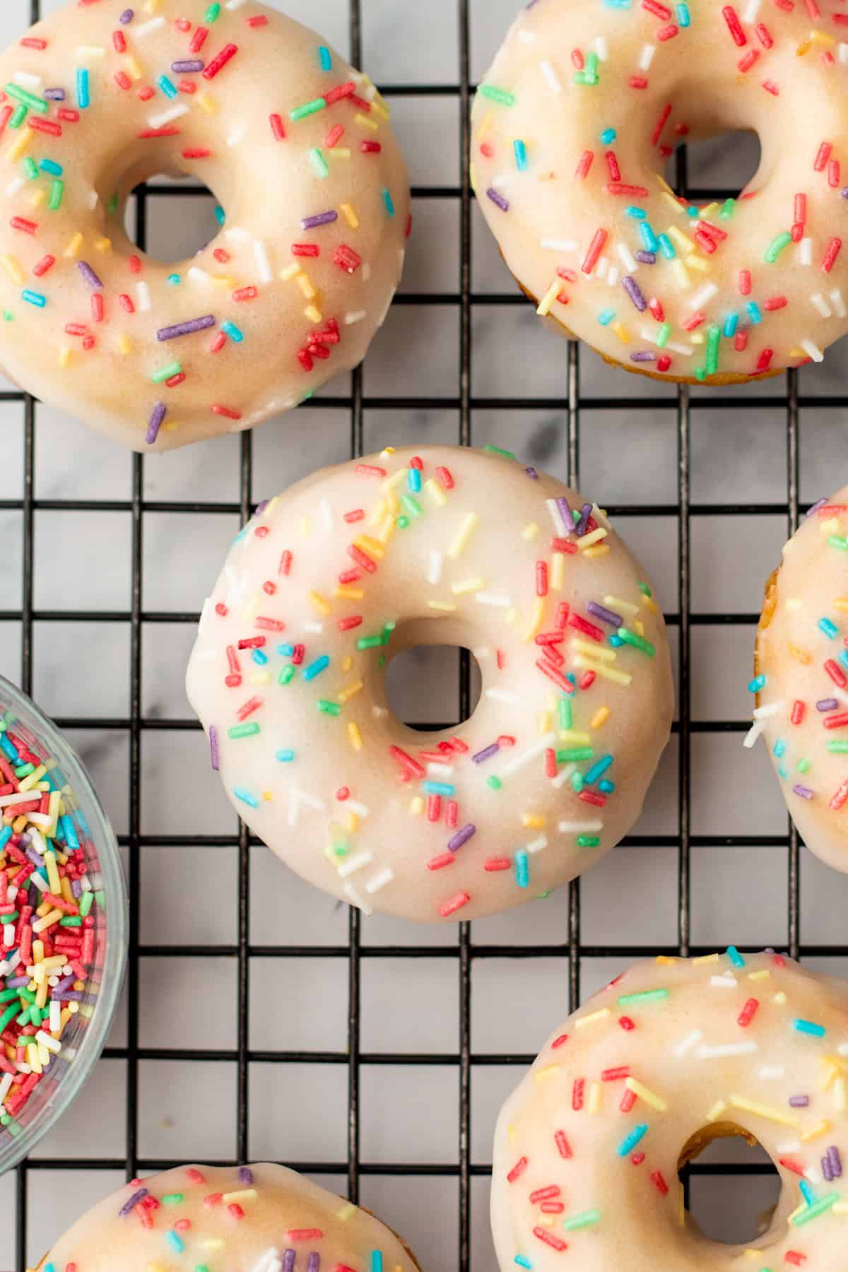 vanilla baked donuts on a cooling rack
