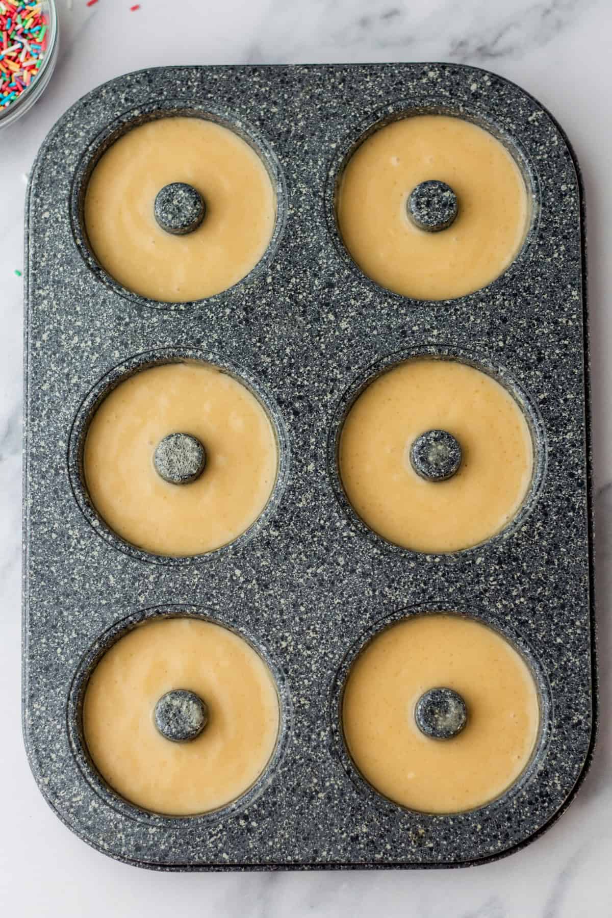uncooked donuts in a donut pan