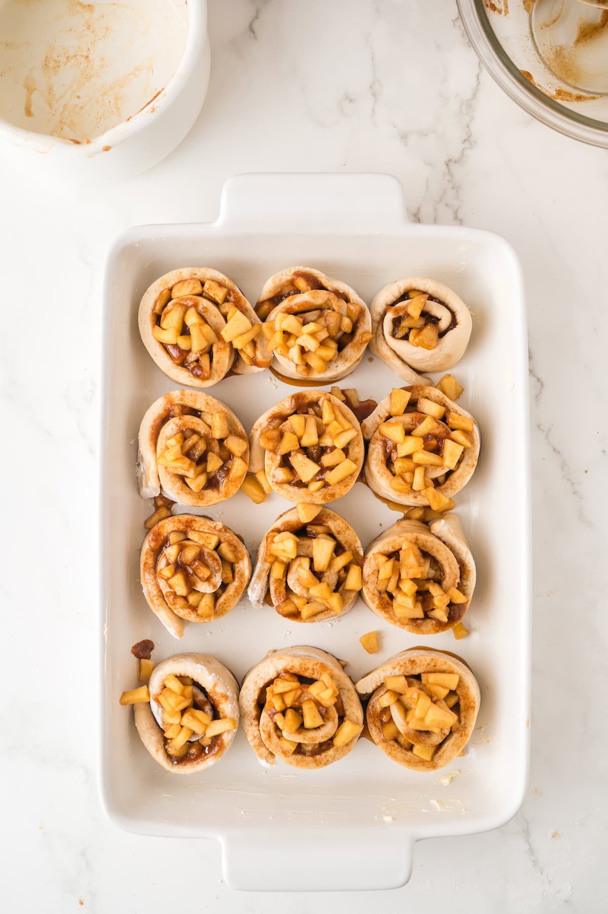 rolled up cinnamon buns in a casserole dish