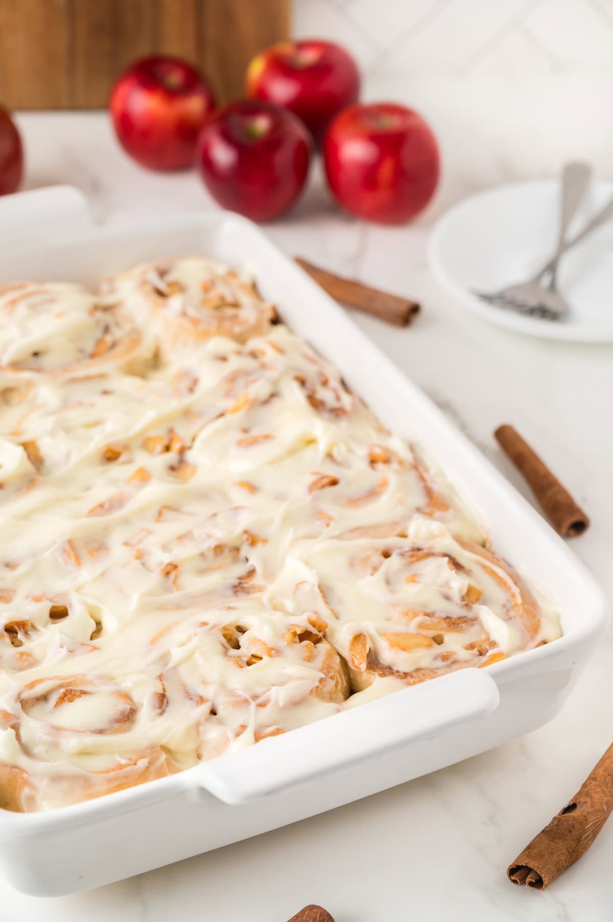 iced cinnamon buns in a casserole dish