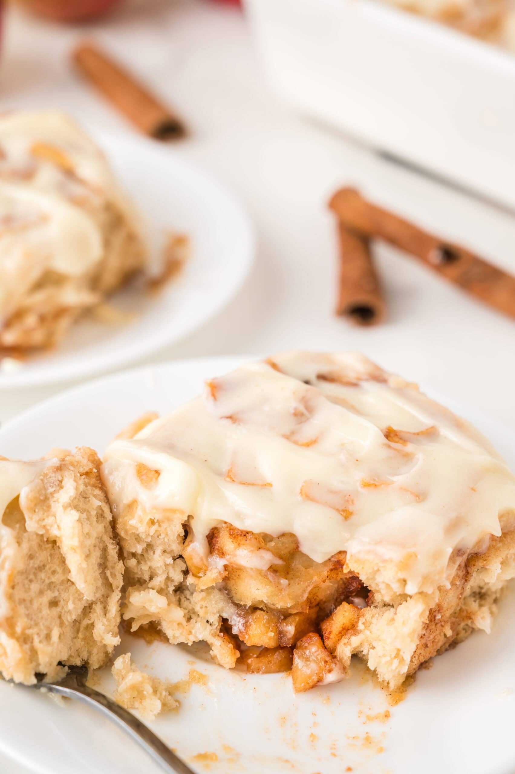 a slice of an apple cinnamon roll on a white plate