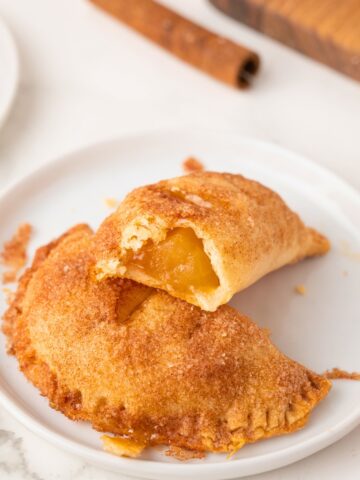 apple hand pies stacked on a plate