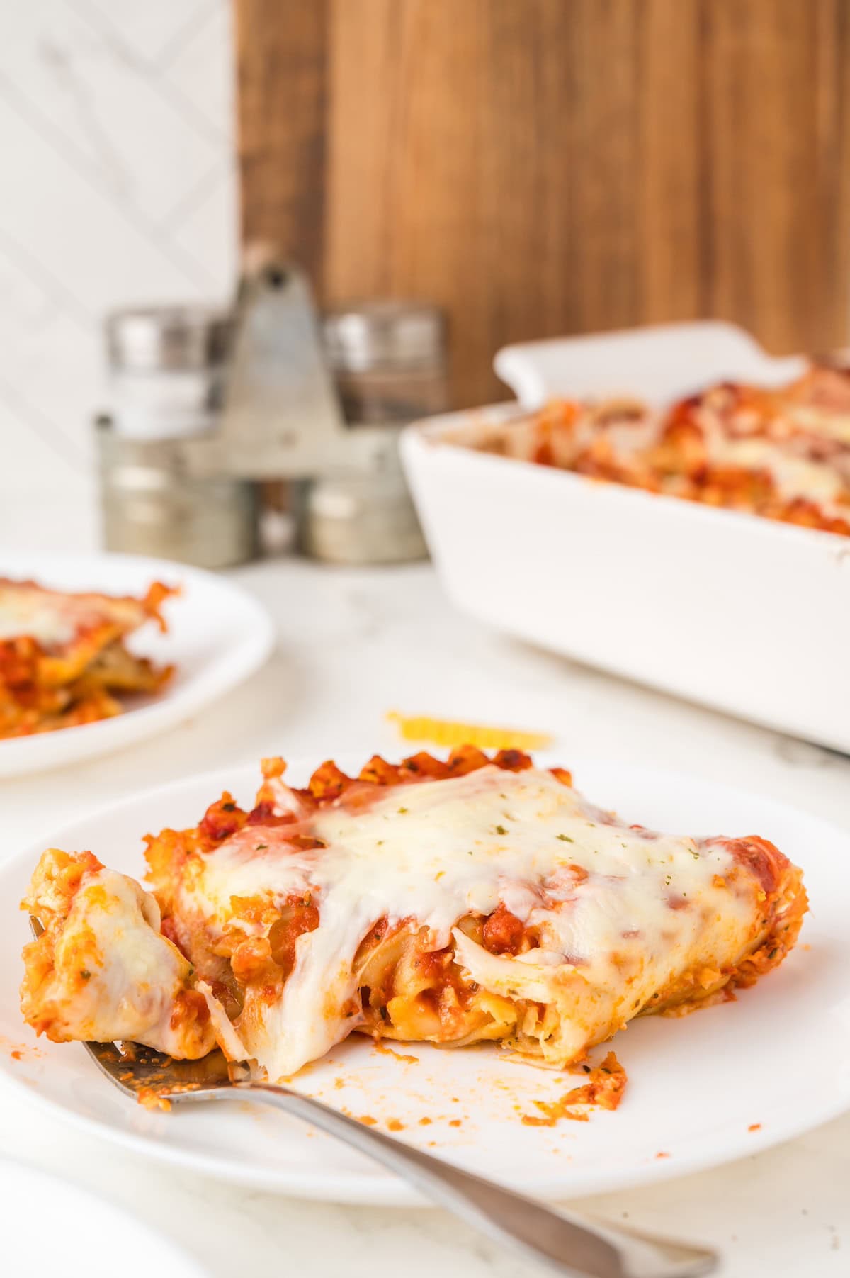 a slice of cheese lasagna on a white plate