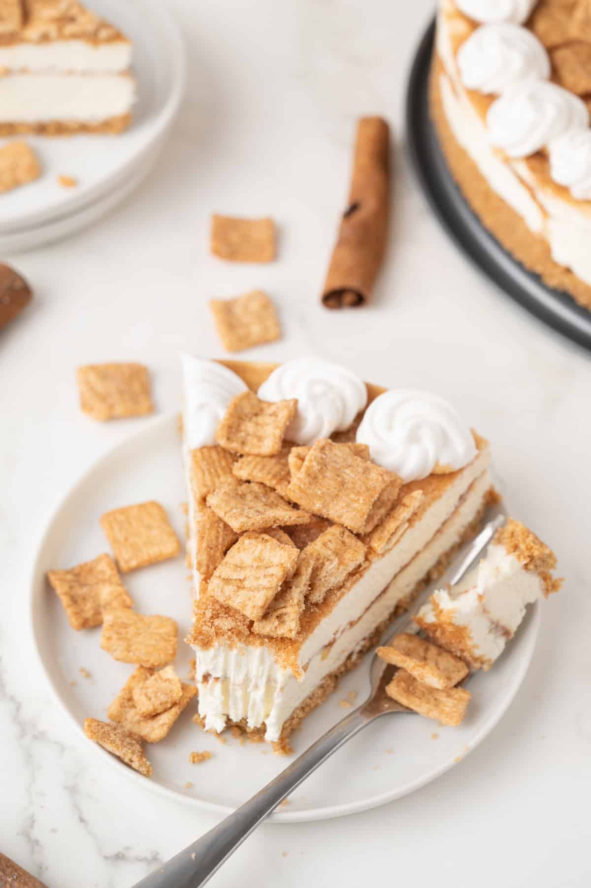 slice of Cinnamon Toast Crunch cheesecake on a white plate