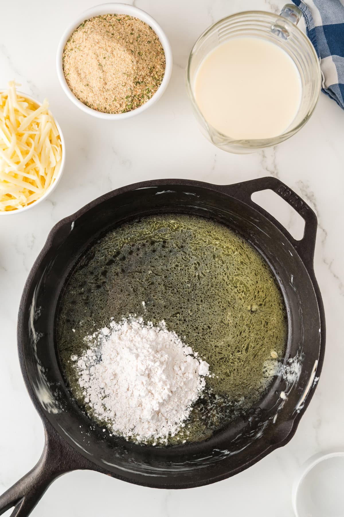 roux being made in a cast iron skillet
