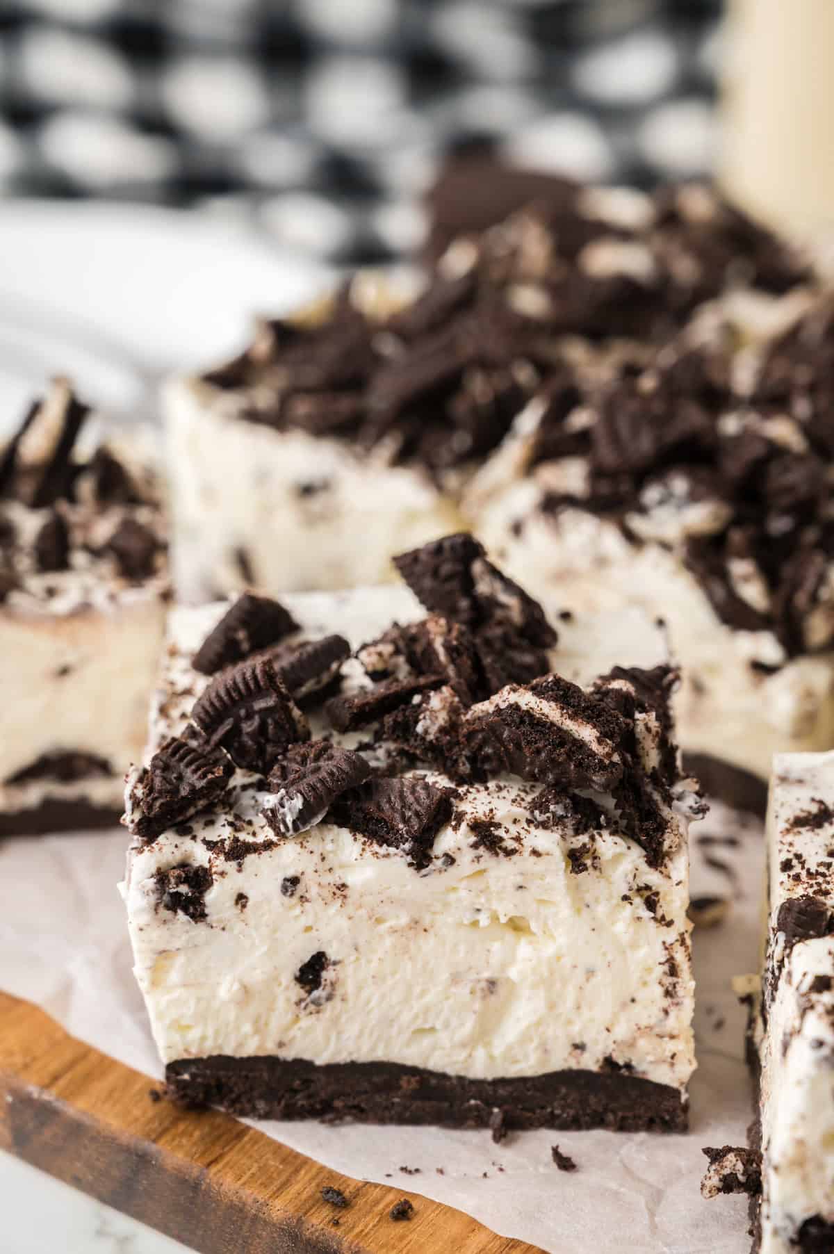 slices of no bake Oreo cheesecake bars on a plate