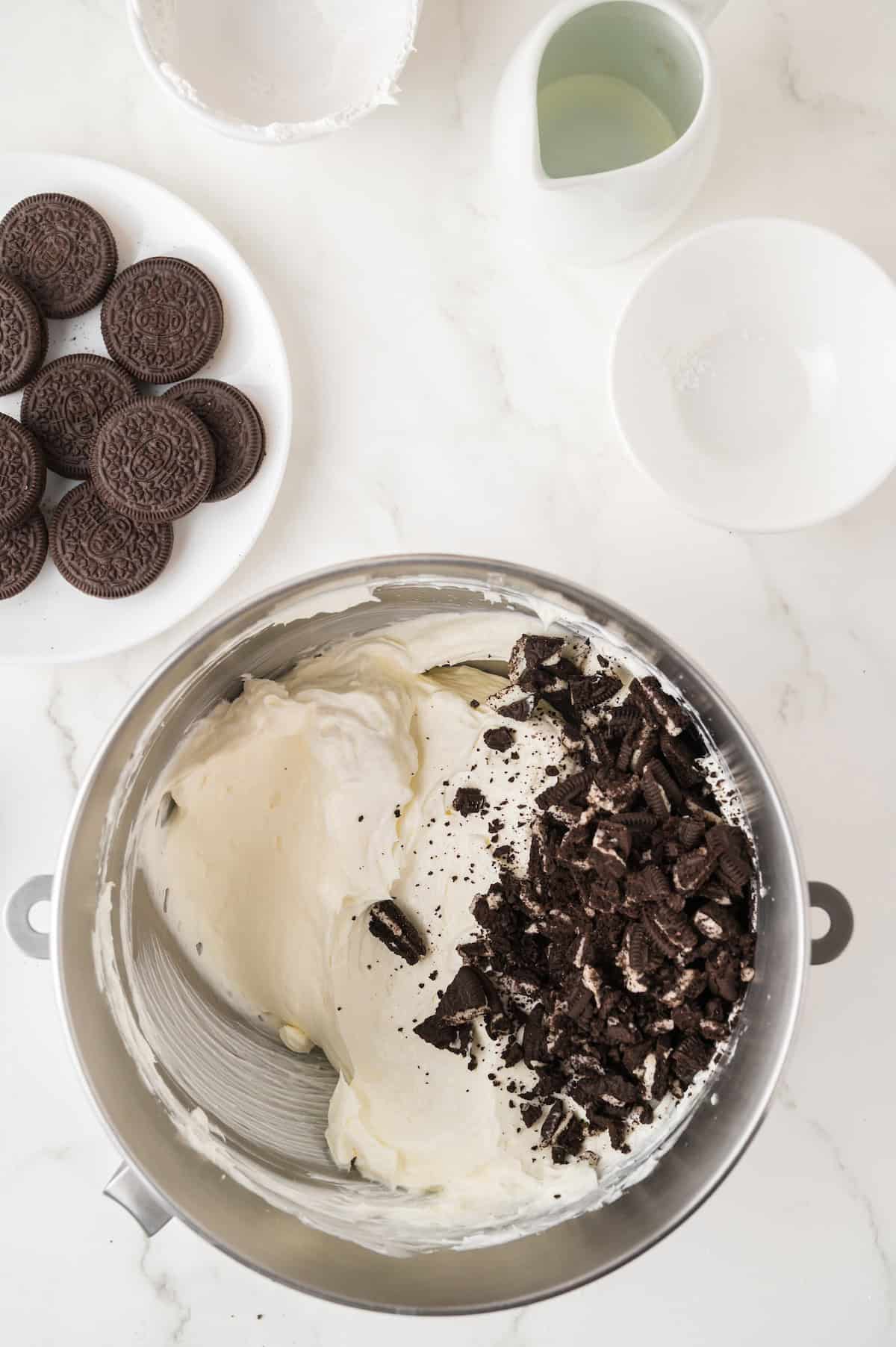 Oreo crumbles and cheesecake filling in a bowl
