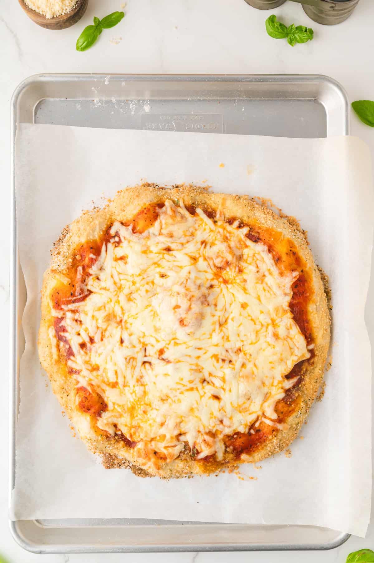 cooked pizza on parchment paper