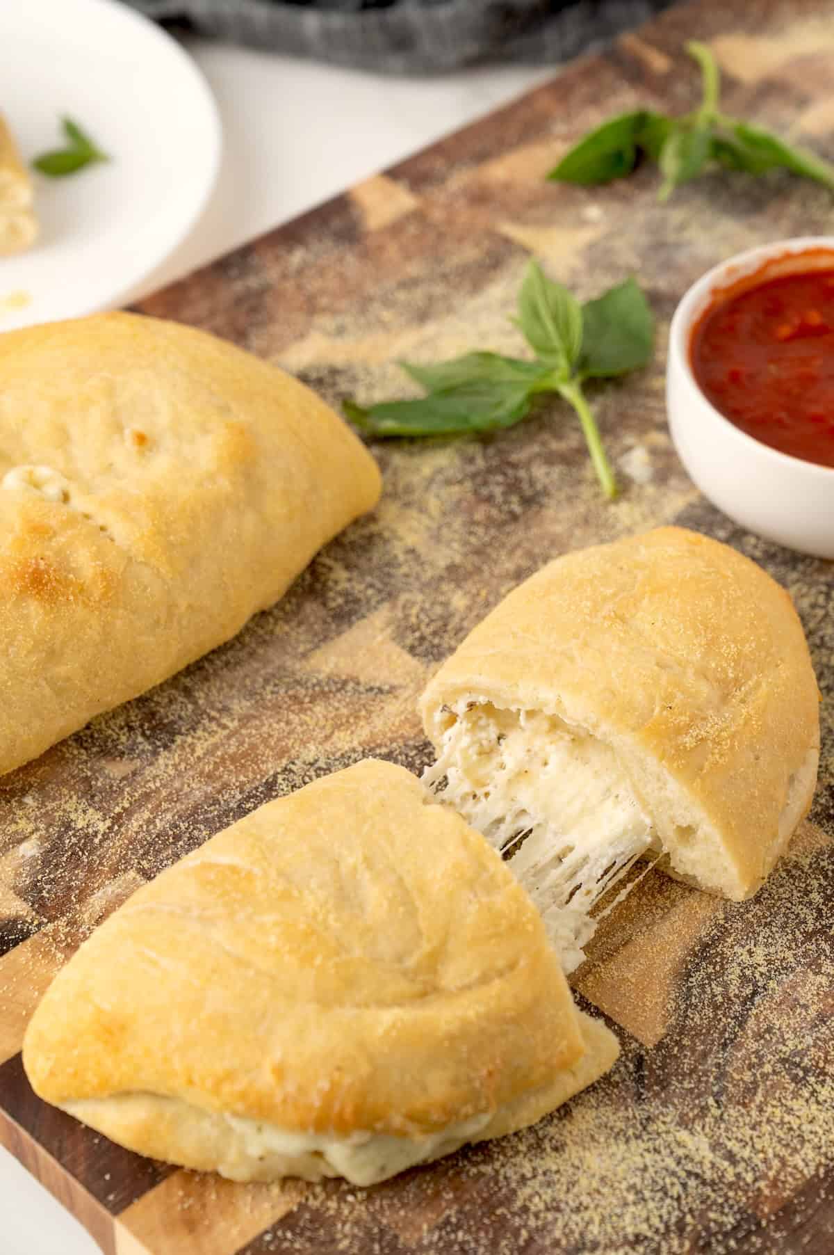 sliced cheese calzone on a cutting board