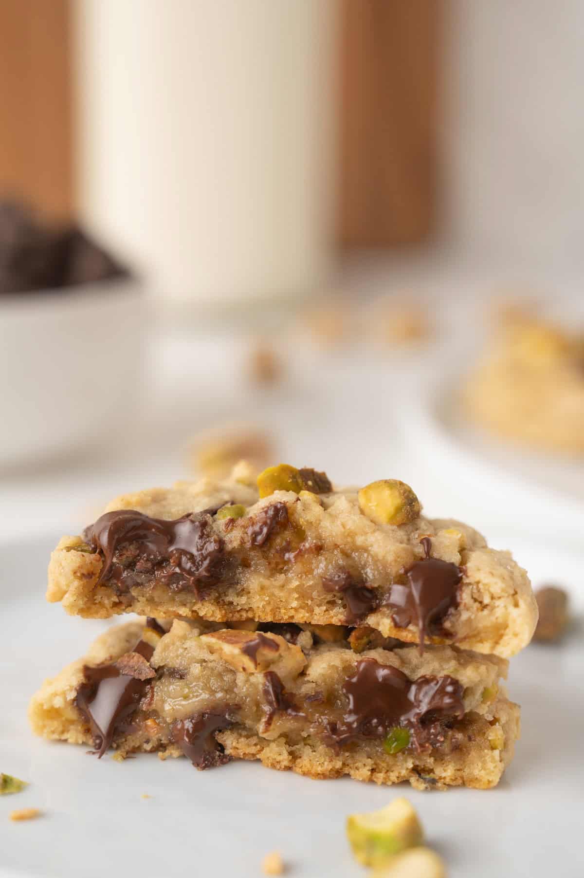 chocolate chip pistachio cookies sliced with melted chocolate.